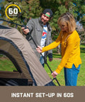 Couple setting up 4 Person Instant Cabin Tent That Pops Up in 60 Seconds with Rainfly and Windproof Design in a park