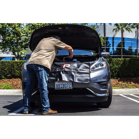 Mechanic using Heavy-Duty 24 By 34 Inch Black Plush Vinyl Fender Cover Pad for auto repair, shielding car paint under hood.
