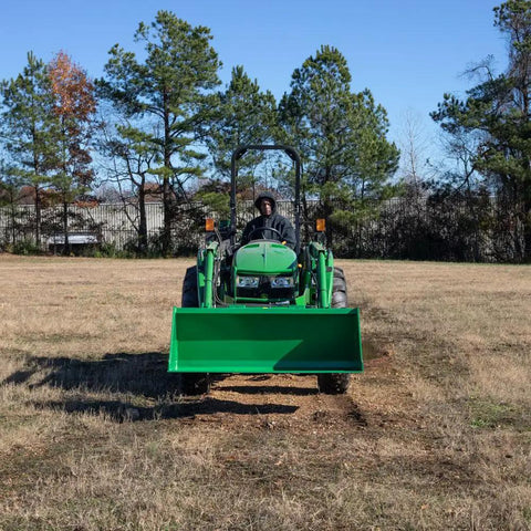 Front view of 5 Foot Dirt Bucket Attachment For Tractors That Fits John Deere Hook And Pin Tractors in open field