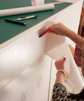 Self Adhesive Decorative Film Whitewood 17 By 78 Inch Roll 4 Pack With Applicator being applied to cabinet.
