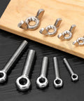 12Pcs M8 X 30mm 304 Stainless Steel Eye Bolts And Wing Nuts Kit on black and wooden background