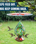 Top Shelf Bird Feeder Baffle And Rain Guard Dome Cover, Ironclad Weatherproof Shield To Keep Squirrels Out And Seed Dry, No Hassle Steel Mount Kit In Bold Red Floral Design over a hummingbird feeder.