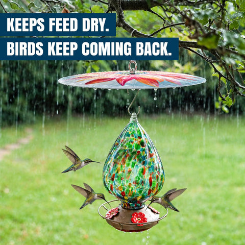 Top Shelf Bird Feeder Baffle And Rain Guard Dome Cover, Ironclad Weatherproof Shield To Keep Squirrels Out And Seed Dry, No Hassle Steel Mount Kit In Bold Red Floral Design over a hummingbird feeder.