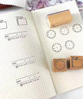 Top Shelf Wooden Stamp Set Featuring Date Time Notes Stamps For Crafting Journaling Planner Organization Durable Natural Wood And Rubber Design Super Slick Ink Application Killer Combo, showing stamps on notebook.