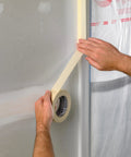 Person applying masking tape for office and home projects with strong adhesive 0.70 inch by 54.6 yard easy apply on clean surface