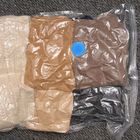 Ultimate Vacuum Seal Kit For Compression Bags with clothes sealed inside using blue valve plug on carpet
