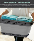 Person holding Big 25 Inch Collapsible Laundry Basket With Dual Comfort Grip Handles Ultra Slim Pop Up Hamper filled with towels
