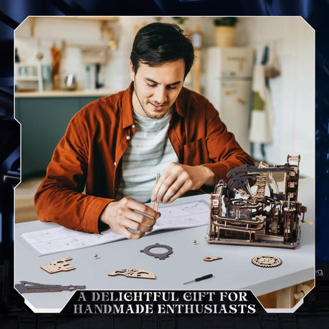 Man assembling Dope 3D Puzzle Marble Run Kit For Adults Electric Spaceport LGC01 With 472 Wooden Pieces on a desk.