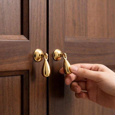 Top Shelf Heavy Duty Solid Brass Cabinet Knob Featuring Slick Brushed Gold Finish Smooth Glide Movement on wooden cabinet doors.