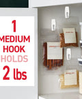 Medium Wire Toggle Hooks Set With 7 Wall Hooks And 8 Adhesive Strips For Damage Free Hanging, holding spice bags on kitchen wall.