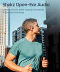 Man jogging in urban setting wearing Next Level Open Ear Bone Conduction Bluetooth Sport Headphones In Black.