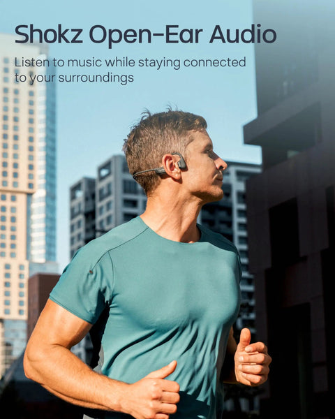Man jogging in urban setting wearing Next Level Open Ear Bone Conduction Bluetooth Sport Headphones In Black.