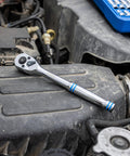 Three Eighths Inch Ratchet Wrench With Hundred Tooth Reversible Gears on engine, Eight Inch Long Handle, Chrome Vanadium Steel