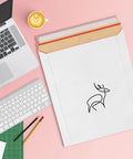 Stay Flat 17 By 21 Inches White Kraft Rigid Mailers Pack Of 50 With Self Seal Closure on a pink desk with laptop and coffee