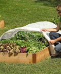 Woman assembling Set Of 6 Garden Hoops Grow Tunnel Supports For DIY Low Tunnel Greenhouse Arch Frame over raised bed
