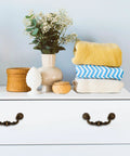 Four Piece 150mm Center Drawer Pull Handles In Zinc Alloy Rustic Vintage Style on white dresser with decor items