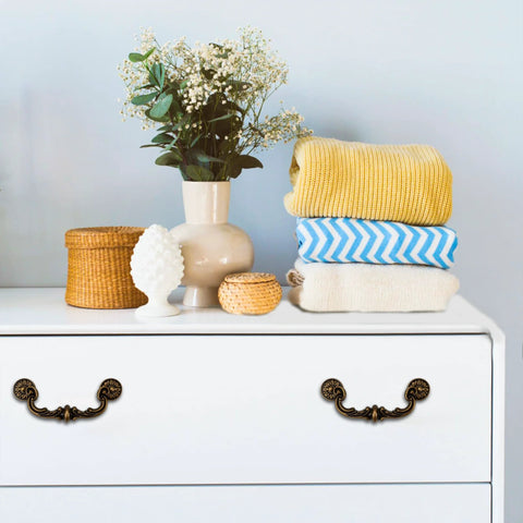 Four Piece 150mm Center Drawer Pull Handles In Zinc Alloy Rustic Vintage Style on white dresser with decor items