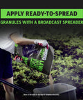 Person spreading Quick Kill Lawn Insect Killer Granules 10 lb Black Label with a broadcast spreader on grass.