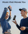 Couple enjoying Beefy Bass Portable Bluetooth Speaker With Crisp Stereo Sound, IPX7 Waterproof, 24 Hour Playtime outdoors.