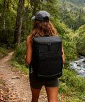 Person hiking with Insulated Leakproof Cooler Backpack With Waterproof Oxford Fabric Large Capacity Holds 30 Cans Lightweight