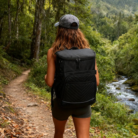 Person hiking with Insulated Leakproof Cooler Backpack With Waterproof Oxford Fabric Large Capacity Holds 30 Cans Lightweight