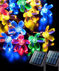Outdoor Solar Cherry Blossom String Lights 2 Pack, 30.6 Ft Each, 50 LED Multicolor Flower Lights, lit at night with solar panels.