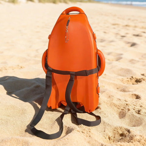 Spearfishing Float Buoy With Foldable Carbon Fiber Flagpole on sandy beach, orange red, with attached straps visible.