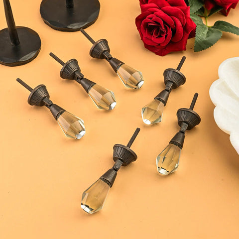 Set Of 6 Clear Glass Iris Knobs For Cabinets Drawers Doors And Wardrobes Modern Sleek Hardware Upgrade For Kitchen Cupboard Dresser And Drawer Pulls Rich Glass Finish displayed on a surface with red rose decoration