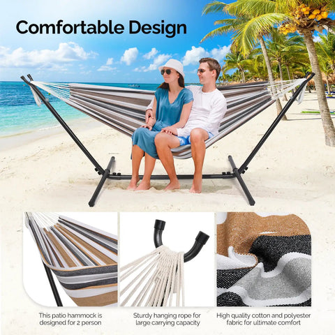 Couple relaxing on 550 lb capacity double hammock with stand, desert stripe design, suitable for outdoors and indoors.