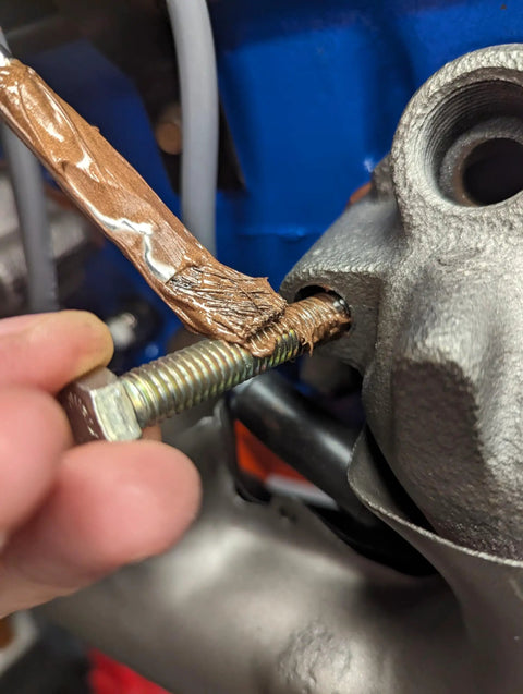 Applying Copper Anti-Seize Compound With Micro Fine Copper Flakes In A Semi-Synthetic Grease Carrier 454 g to threaded fastener.