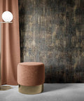 Peel And Stick Wall Covering With Industrial Textured Metallic Look In Charcoal And Gold Adhesive Distressed Wallpaper Roll About Twenty Nine Square Feet Coverage Easy Install Seventeen Point Seven Inches Wide By Two Hundred Thirty Six Inches Long behind a lamp and stool