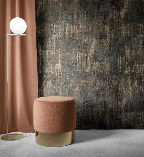 Peel And Stick Wall Covering With Industrial Textured Metallic Look In Charcoal And Gold Adhesive Distressed Wallpaper Roll About Twenty Nine Square Feet Coverage Easy Install Seventeen Point Seven Inches Wide By Two Hundred Thirty Six Inches Long behind a lamp and stool