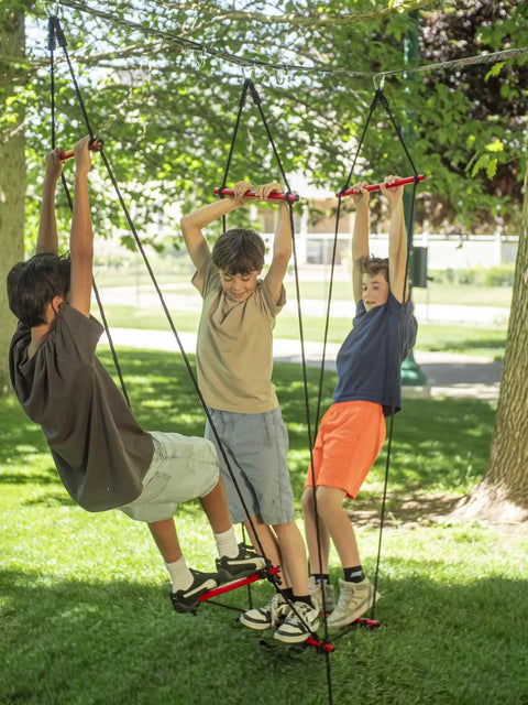 Kids swinging on Ninjaline Obstacle Course Kit For Backyard Ninja Warrior Training 56 Ft Deluxe Set ropes and bars outdoors