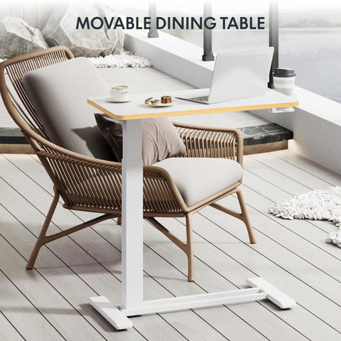 32 Inch Mobile Standing Desk Featuring A Slick Rolling Base And Hassle Free Pneumatic Height Adjustments With Smooth One Hand Gas Spring Lift For Compact Home Office Computer Workstation Setup next to a modern chair.