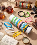 Bulk 48 Piece Science Silicone Wristbands Set for Classroom Rewards and Teacher Gifts displayed with lab equipment