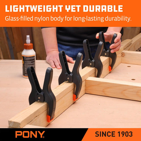Heavy Duty Nylon Spring Clamp Set With Adjustable Jaw Pads, four clamps securing wood on workbench.