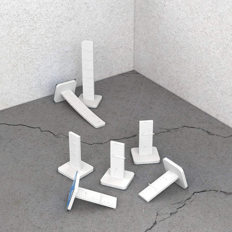 Model 82 289 Leveling Pins 50 Pack For Concrete Pours With Self Adhesive Backing shown on concrete surface