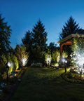 10 Pack 5W Outdoor LED Landscape Spotlights, 5000K Daylight Brightness For Flags And Gardens, Waterproof Low Voltage 12V-24V AC DC Yard Light, illuminating a garden at night.