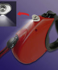Red retractable leash with Ultra Compact Stick On LED Thumb Light turning it into a bright flashlight with water resistant design.