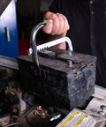 Person using Heavy Duty Battery Carrier Lifter And Grab Tool For Top Post And Side Post Batteries With Rubber Pad Grip on car battery