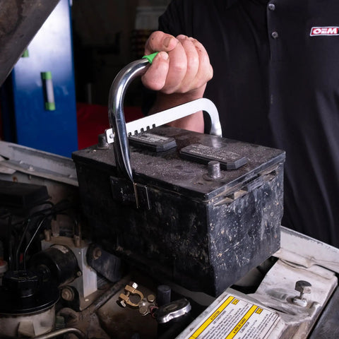 Person using Heavy Duty Battery Carrier Lifter And Grab Tool For Top Post And Side Post Batteries With Rubber Pad Grip on car battery