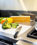 Chopped broccoli on EZ Board Disposable Plastic Cutting Board For Quick Cleanup And Easy Food Prep On The Go in kitchen.