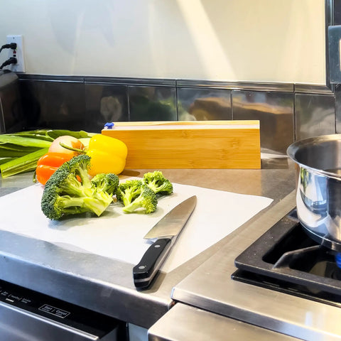 Chopped broccoli on EZ Board Disposable Plastic Cutting Board For Quick Cleanup And Easy Food Prep On The Go in kitchen.