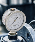 Industrial liquid filled pressure gauge for 0-100 psi reading, stainless steel, brass internals, ideal for pumps and compressors