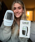 Smiling person holding a Portable Space Heater With Remote, 500W Ceramic Electric Heater for Small Bedroom, Office, or Garage.