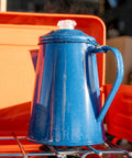 Percolator Coffee Pot For Campfire Brewing, Enamel Camping Kettle on stove delivering rich bold coffee outdoors