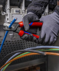 Person using StepCut XL Cable Shears 9 Inch High Leverage For Thick Cables with Easy Grip Comfort Handles on blue cable.