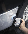 Cordless Power Scrubber Auto Detailing Kit With Four Cleaning Pads, Bristle Brush, Splash Guard, And Charger in use on car bumper