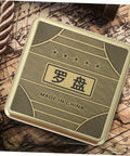 Top view of a Small 10cm Alloy Feng Shui Compass With Flip Cover, Waterproof Outdoor Navigation Tool, on an old map background.