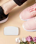 10Pk Self Adhesive Sneaker Heel Repair Patches on the floor next to pink and black running shoes, ideal for shoe repair.